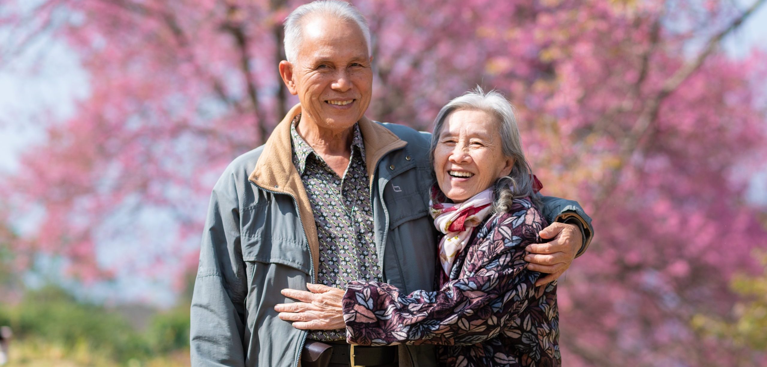 Happy old couple smiling in a park.