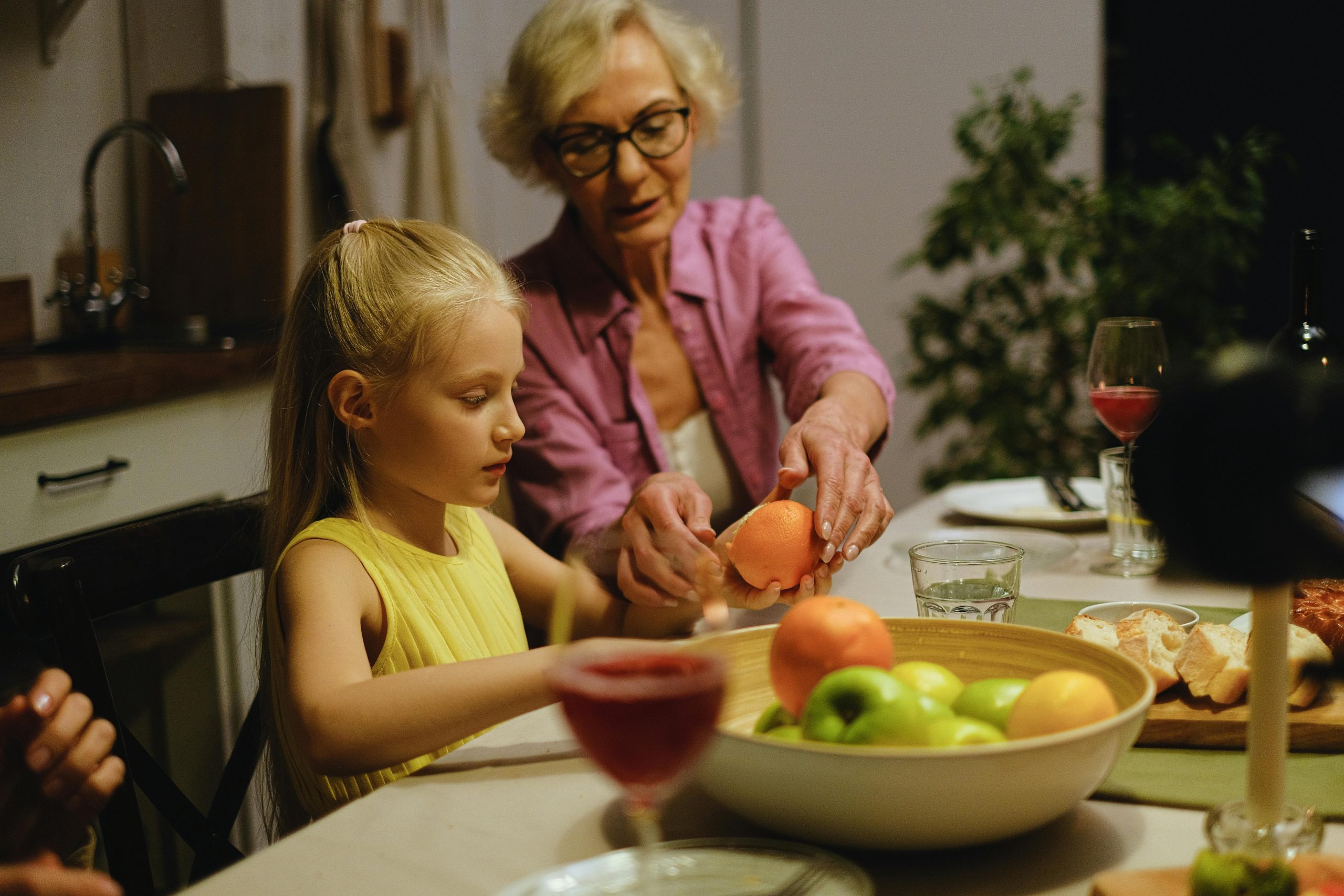 senior and granddaughter cooking together in kitchen